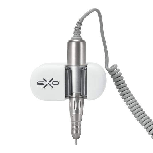 Exo universal adhesive holder for nail drill handpiece mounted on a desk