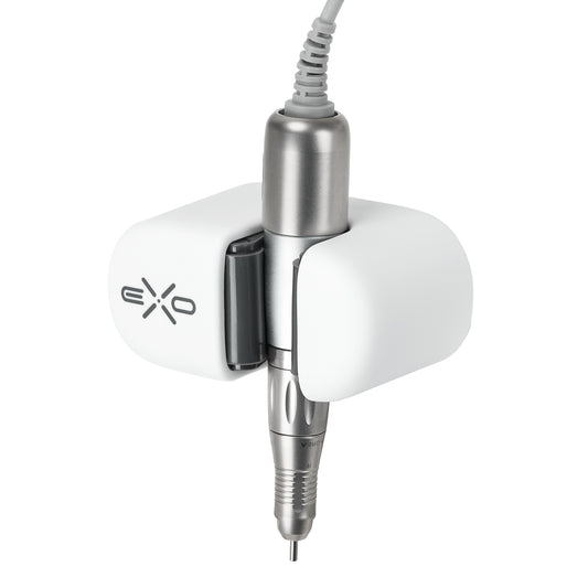 Exo universal adhesive holder for nail drill handpiece mounted on a desk