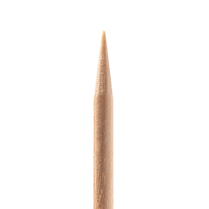 Pointed end of an Ocho Nails wooden cuticle stick for cleaning under the nail